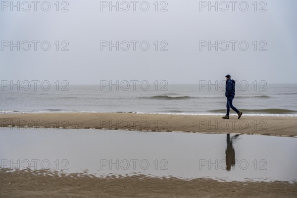 East beach of the East Frisian island of Spiekeroog, beach walk, man alone on the beach, at low