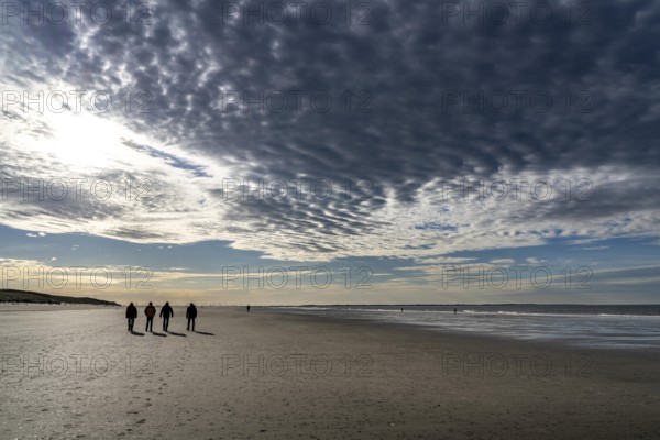 Walkers on the Wadden Sea near the East Frisian island of Spiekeroog, west of the North Sea island,