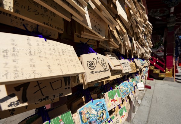 Ema, small wooden tablets with wishes and prayers, hung so that the Kami spirits or gods can