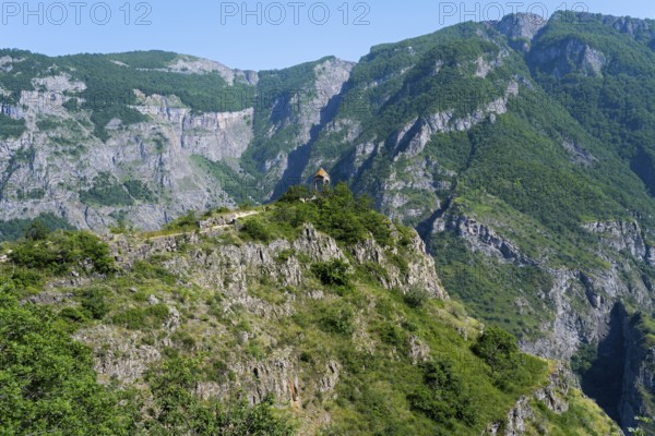 Small rotunda on a green mountainside with majestic rock formations, Halidzor observation deck,