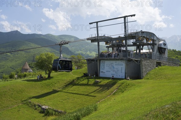 Cable car station on a green hill with views of the surrounding mountain landscapes, Tatev cable