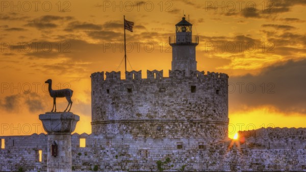 Agios Nikolaos fortress, historic castle with statue in front of a warm sunrise sky, UNESCO World