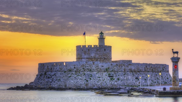 Agios Nikolaos fortress, picturesque castle with lighthouse at sunrise, surrounded by calm sea,