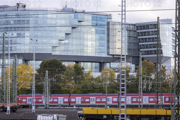 Modern architecture of the Mercedes-Benz Van Technology Center (VTC), in front of it an S-Bahn and