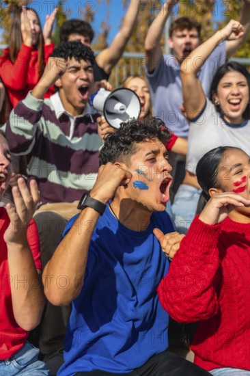 Young diverse people in a stadium are intensely cheering and shouting, supporting their team while