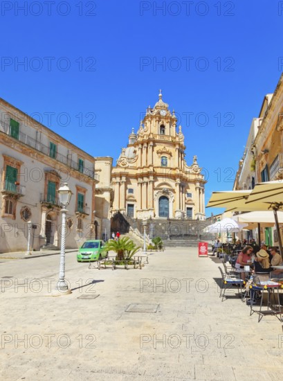 Tourists sitting in local restaurants in the main square, Ragusa Ibla, Ragusa province, Sicily,
