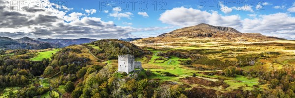 Autumn colours over Castell Dolwyddelan and Eryri Mountains from a drone, Snowdonia, Conwy County