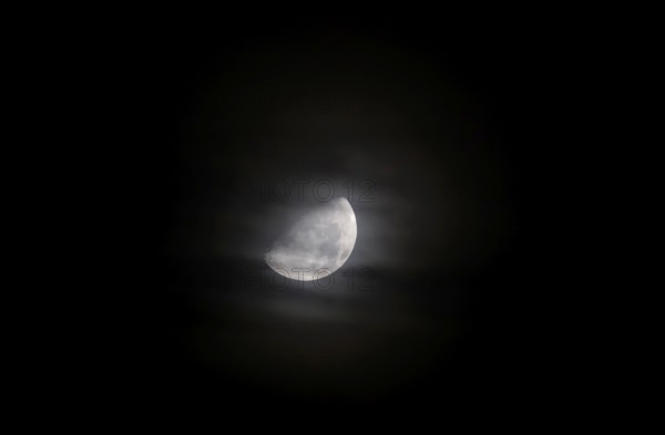 Moon at night behind veil clouds, autumn, Germany