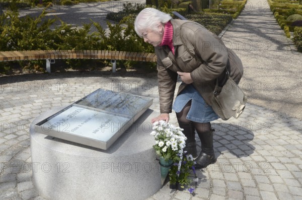 A woman looks at The grave of the love couple Danish circus artist Elvira Madigan Hedvig Jensen and