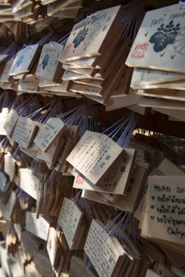 Ema, small wooden tablets with wishes and prayers, hung so that the Kami spirits or gods can
