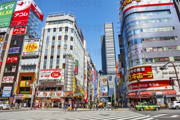 Bustling street scene in Japan with modern buildings and colorful billboards, figure of Godzilla
