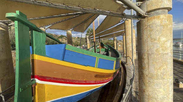 Monument to traditional fishing boats abandoned jacked up typical colorful painted old fishing boat