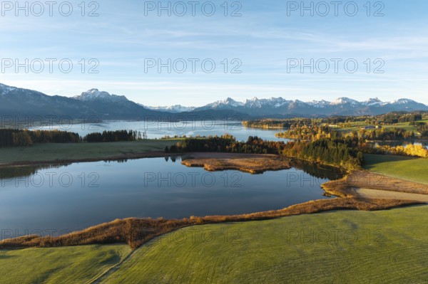 Landscape with a quiet lake surrounded by mountains and autumn vegetation, Illasbergsee,