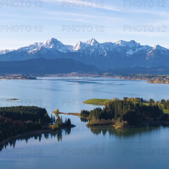 Quiet water area with forest islands and mountain range in the background, Illasbergsee,