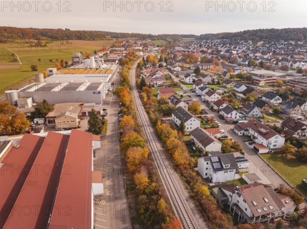 An autumnal panorama with a Hermann Hesse Railway railway line red roofs and residential buildings