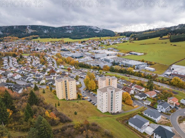 View of village with colorful autumn leaves and dark clouds, Wehingen, Tuttlingen district, Germany