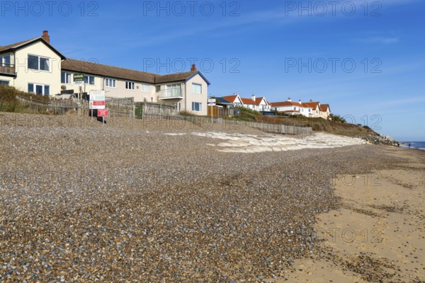 For Sale estate agent signs outside houses at risk of coastal erosion, Thorpeness, Suffolk, North