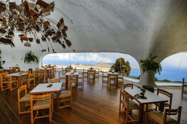 Interior of café with panoramic window in building designed by Cesar Manrique with the