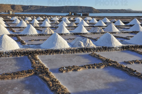 Small conical mounds of sea salt in historic saline for salt production Las Salinas de Janubio,