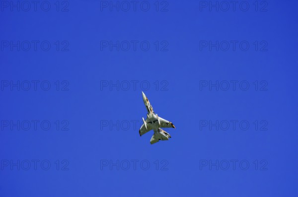 A single-jet fighter jet during a flight demonstration as part of an air show at the Rossfeld Air