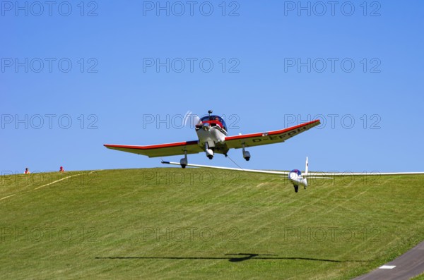 A Robin DR 400/200R Remorqueur light aircraft, registration D-EFGH, tows a glider during a flight