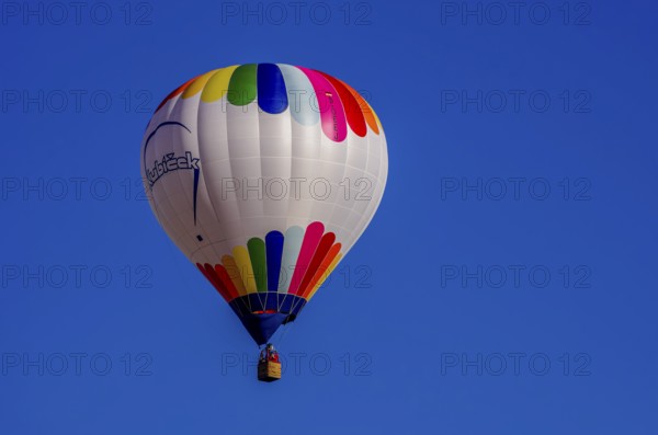 A hot air balloon, registration D-OÖJ, rises into the air as part of an air show at the