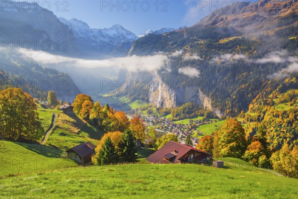 View from the village of the Lauterbrunnen Valley with Staubbach waterfall in autumn with morning
