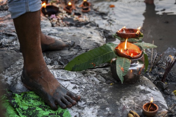 A Hindu devotee offer prayers to the Sun God on the bank of Brahmaputra river on the occasion of