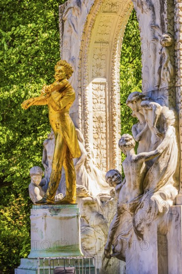 The gilded bronze statue of Johann Strauss, the Waltz King, memorial in the municipal park, Vienna,