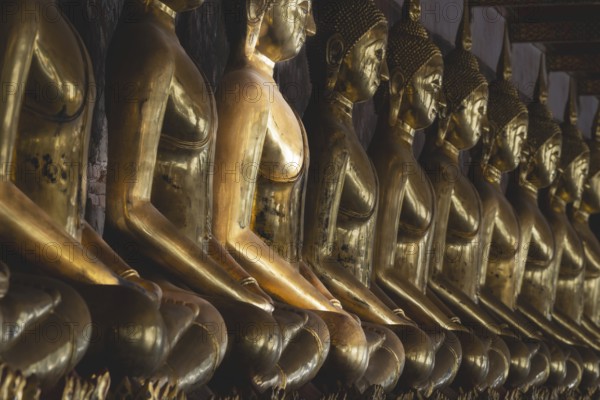 Gilded Buddha statues (Bhumispara mudra: Buddha Gautama at the moment of enlightenment), Wat Suthat
