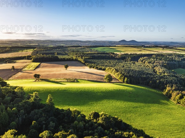 Fields and Farms over River Teviot and Minto Crags from a drone, Roxburghshire, Scottish Borders,