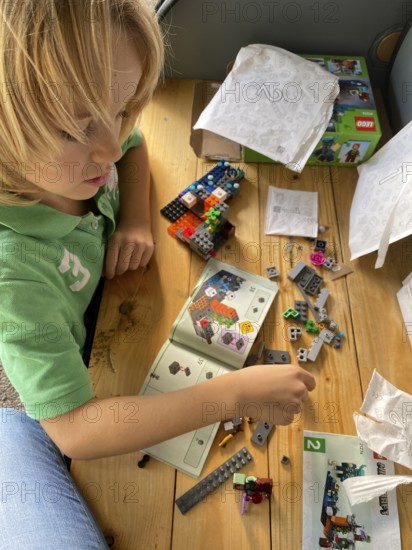 Child, boy, 7 years, blonde, playing with Lego, building kit, Stuttgart, Baden-Württemberg, Germany