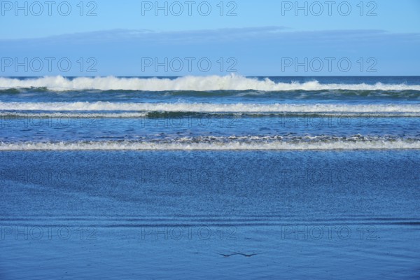 Gentle waves meet the beach, sky and sea in harmony, Spencer Park Beach, Spencerville,