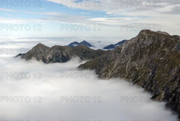 View from the Nebelhorn summit to mountains of the Allgäu Alps, mountains rising from fog in the