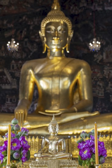 Golden Buddha statue, Phra Buddha Trilokachet surrounded by exquisite wall paintings, interior view