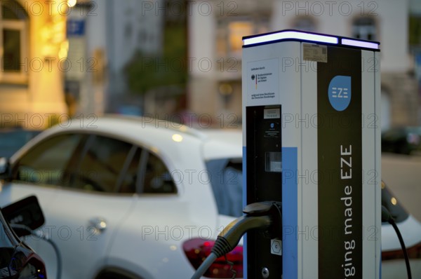 Parking lot with gas pump, EZE Network charging station, SICHARGE model for electric cars, charging