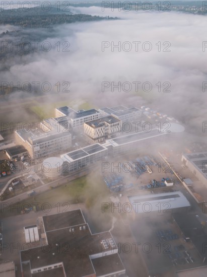Wide landscape with industrial complex in fog from an aerial perspective, new hospital health