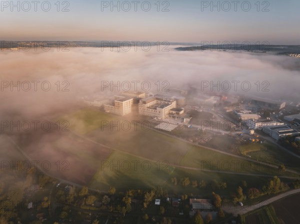 View of buildings in fog surrounded by landscape at the beginning of the day, new hospital health