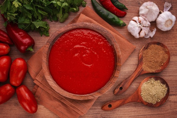 Georgian sauce, Satsebeli sauce, tomato and sweet pepper sauce, with spices, in a wooden bowl,