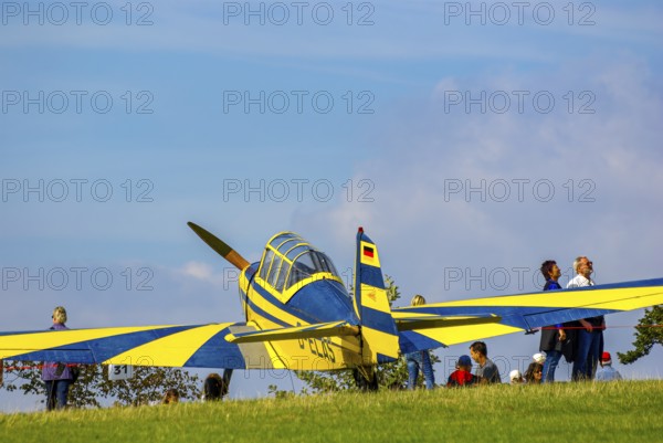 A Moravan Zlin Z126 multi-purpose aircraft parked at the edge of the airfield during an air show at