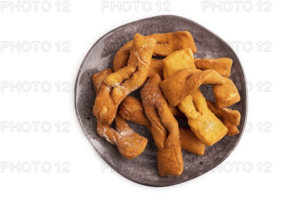 Crunchy biscuit Brushwood cookies sprinkled with powdered sugar isolated on white background, top