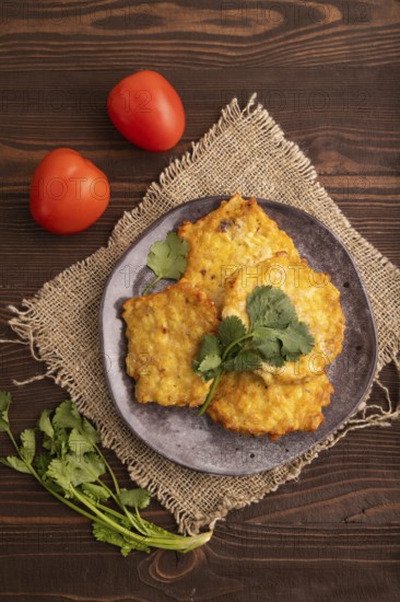 Fried crispy Chicken pancakes on brown wooden background and linen textile. top view, flat lay,