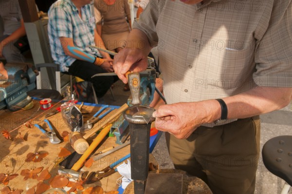Tinsmith at work, old trade, tinsmiths or plumbers are craftsmen who take care of metal products.