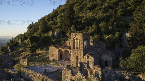 Church of Agia Sophia from the 14th century AD, An ancient church and ruins are bathed in warm