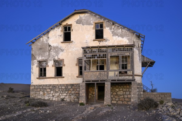 Dilapidated building in the desert sand, blue hour, Kolmanskop, near Lüderitz, Karas region,