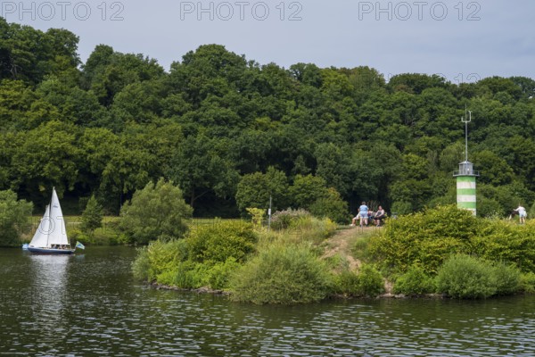 Lighthouse on an island on Lake Kemnader, people on the island, Heveney, Witten, Ruhr area, North