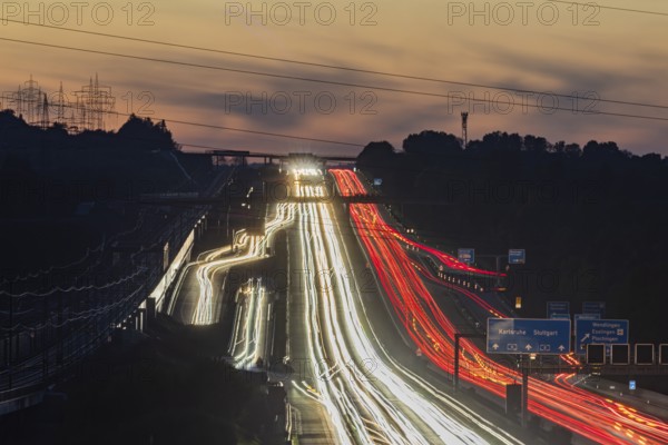 Motorway near Stuttgart with several lanes in the evening with sunset. Heavy traffic with light