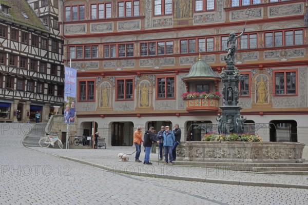 Renaissance town hall with Neptune fountain, market stall and pedestrians, Am Markt, Tübingen,