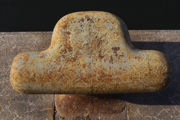 Close-up of bollard with flaking paint and rust spots on King Edward pier in Old Port of Montreal,