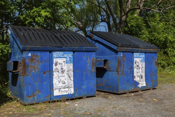 Blue metal with black plastic lid industrial size recycling bins for depositing glass, metal and